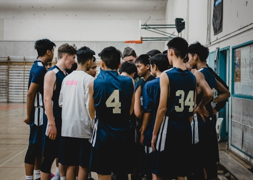 Basketball team huddle in gymnasium