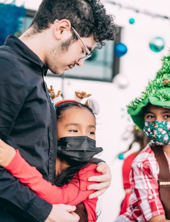 Teacher with students during holiday celebration